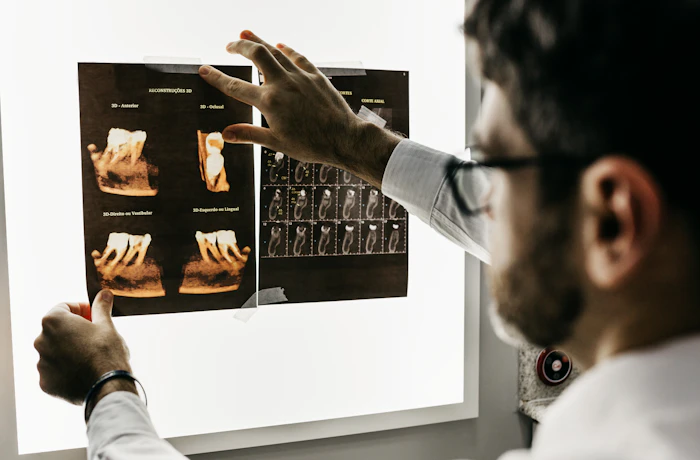 Illustrative dentist reviewing dental imaging